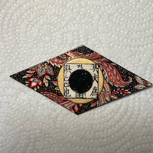 Paper mache lapel brooch.